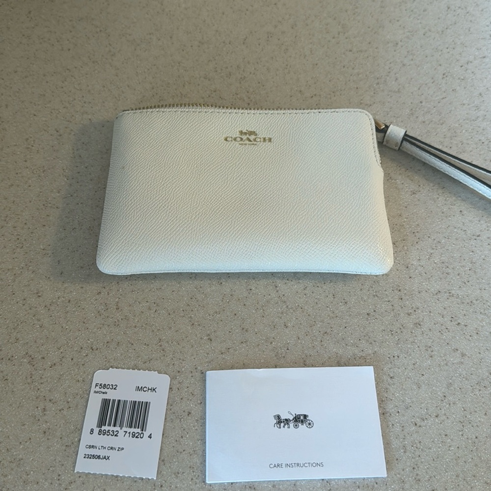New with tags coach wristlet off white. One minor flaw refer to picture
